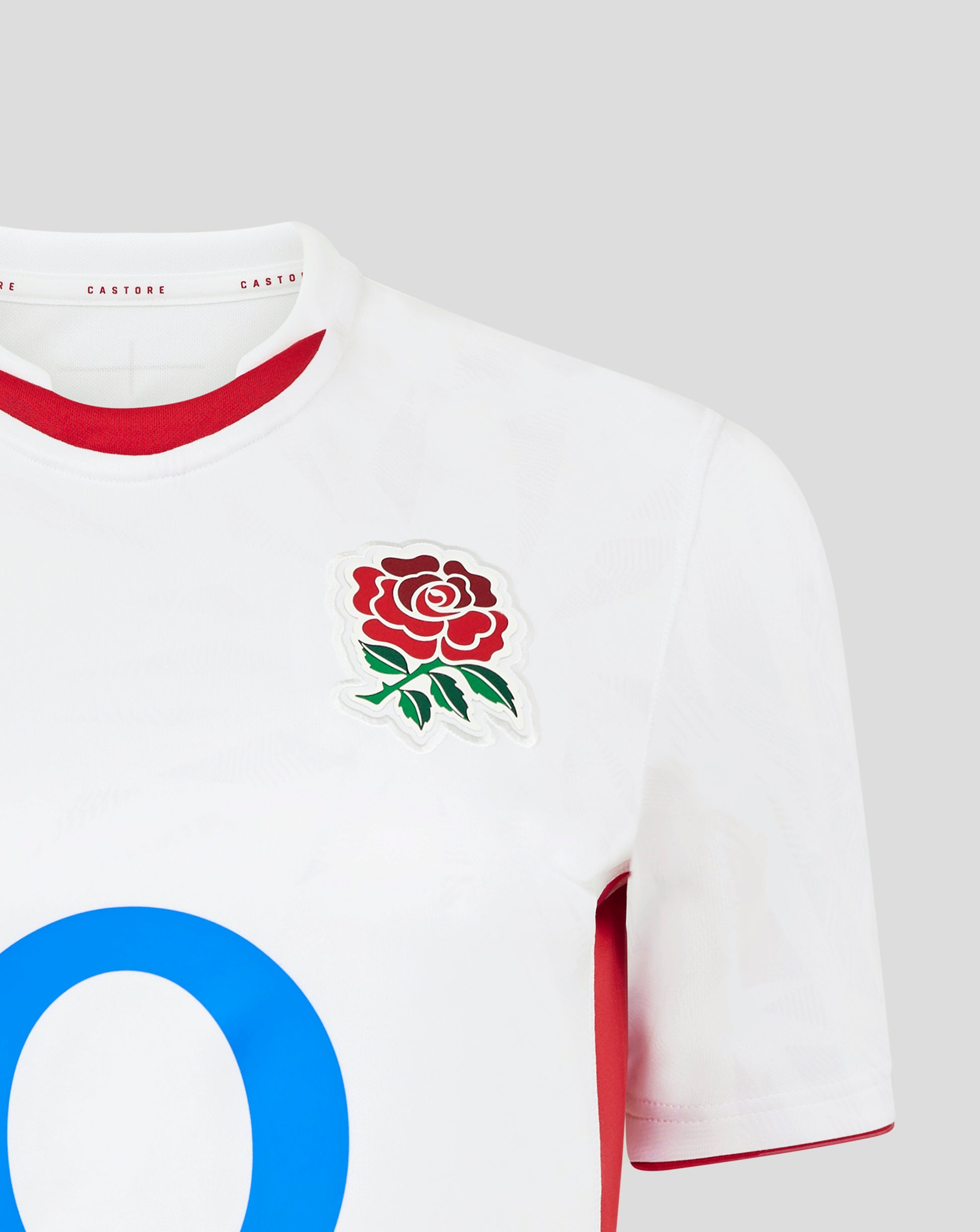 Close up of the white England Rugby home shirt neck area showing red trim inside the collar and a partial red rose crest on the chest