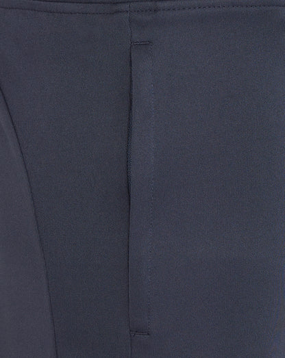 Close-up of navy knit shorts fabric with a vertical seam line and neat stitching