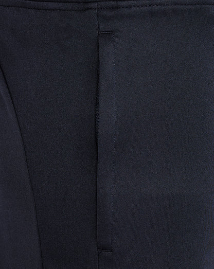 Close-up of the waistband area on navy knit shorts showing stitching and seam detail