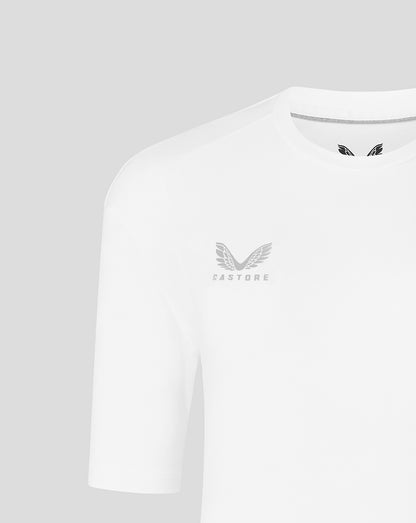 Shoulder and chest close up showing Castore logo and wing emblem on white tee.