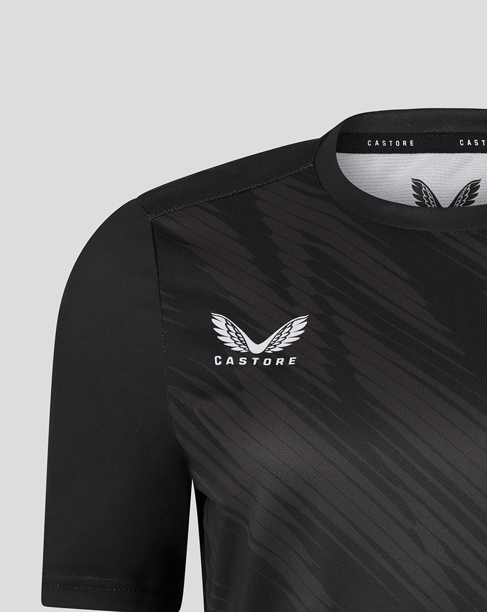 Shoulder and chest close up of black Leicester Tigers women's warm up T shirt showing Castore branding and tiger crest