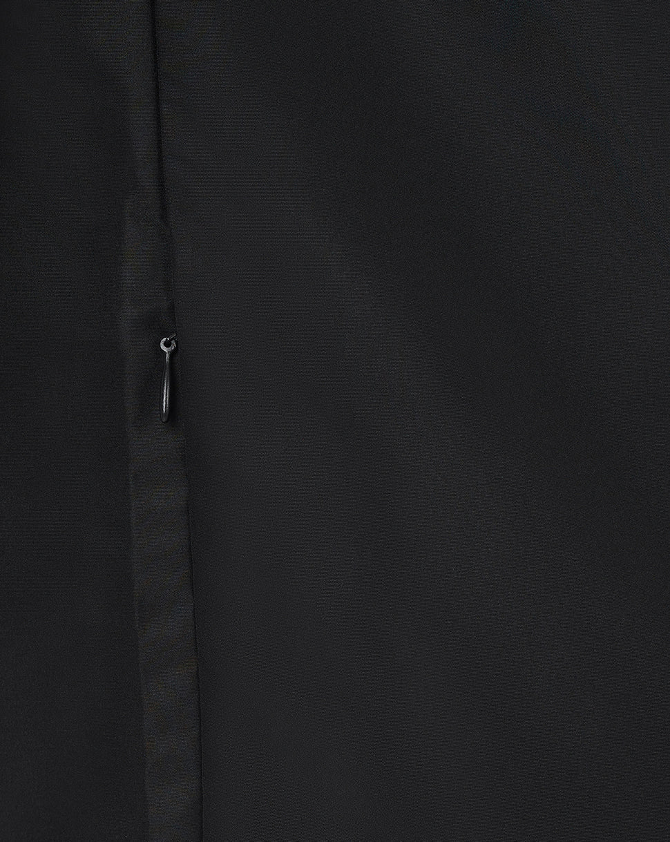 Close up of black woven fabric with a small zipper pull from the Leicester Tigers women's pre match jacket