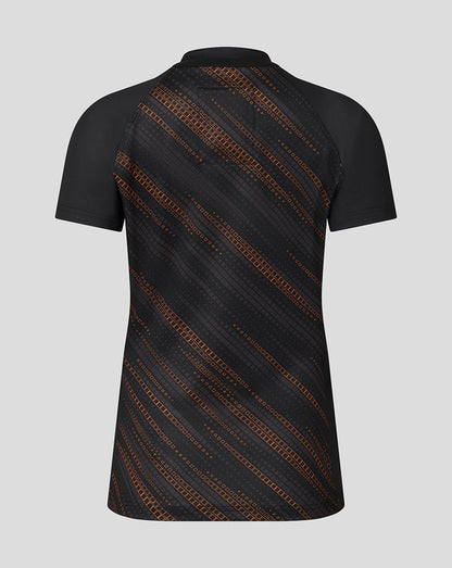 Back view of black Leicester Tigers Women's 25/26 warm up jersey featuring an orange diagonal pattern