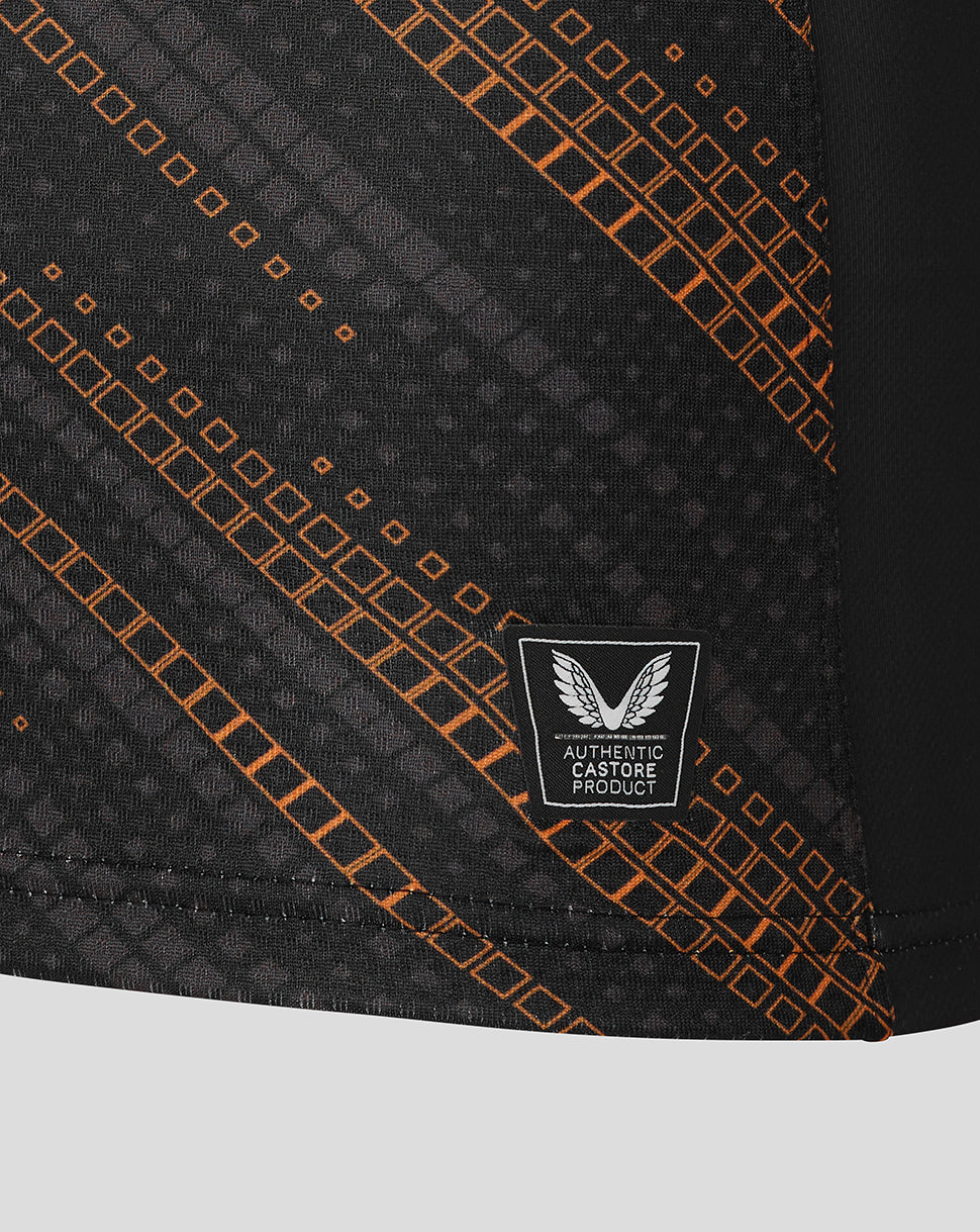 Close-up of black Leicester Tigers warm up jersey fabric with orange diagonal grid pattern and authentic Castore product badge