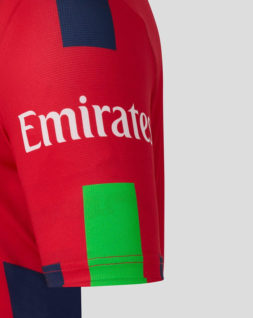 Close-up of red Lancashire T20 jersey sleeve with Emirates logo and lime green patch.