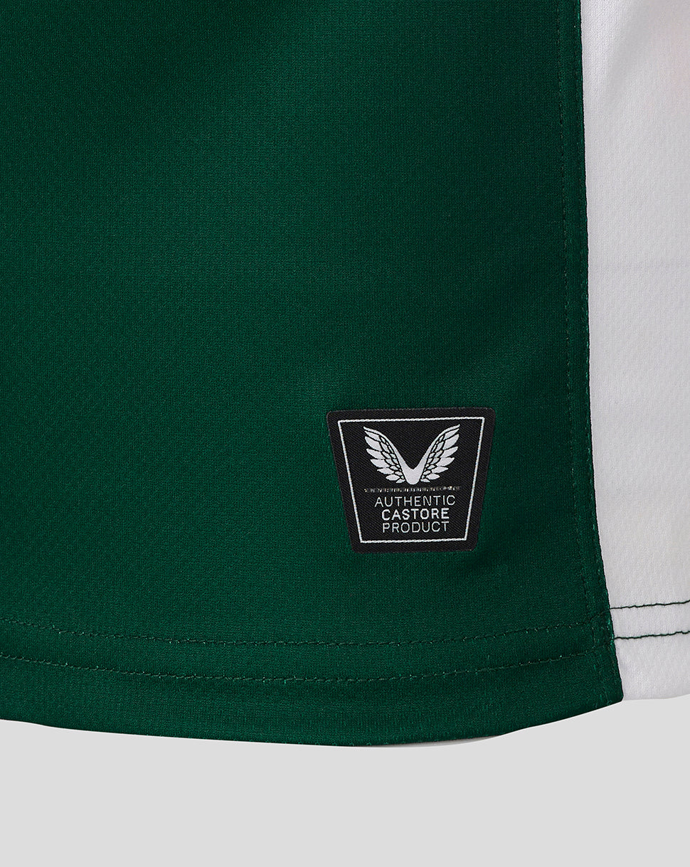 Lower hem of the Leicester Tigers shirt with authentic Castore product patch on green fabric