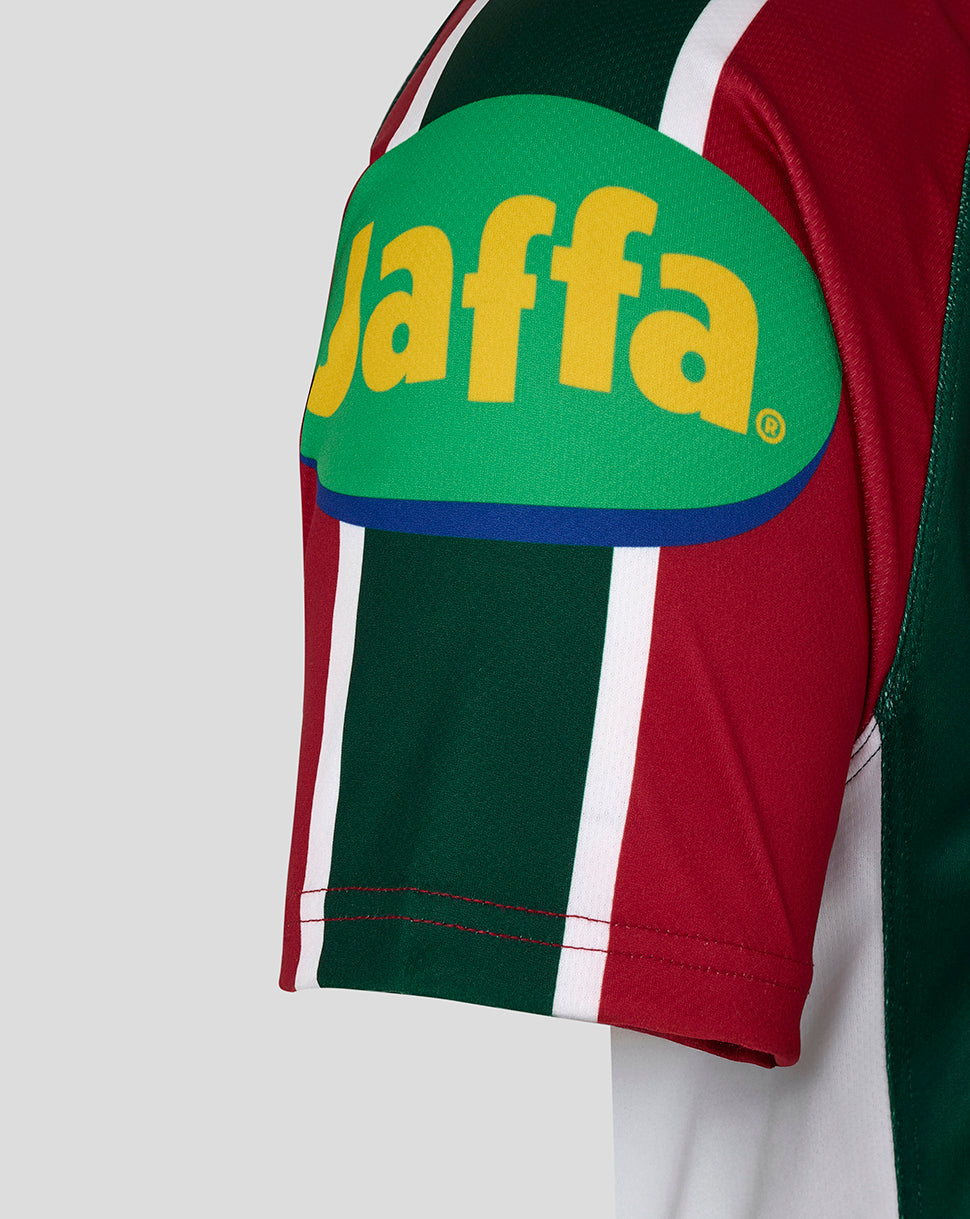 Shoulder patch on the sleeve featuring a bright green Jaffa logo with yellow lettering on the red and green striped jersey.