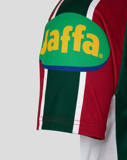 Shoulder patch on the sleeve featuring a bright green Jaffa logo with yellow lettering on the red and green striped jersey.