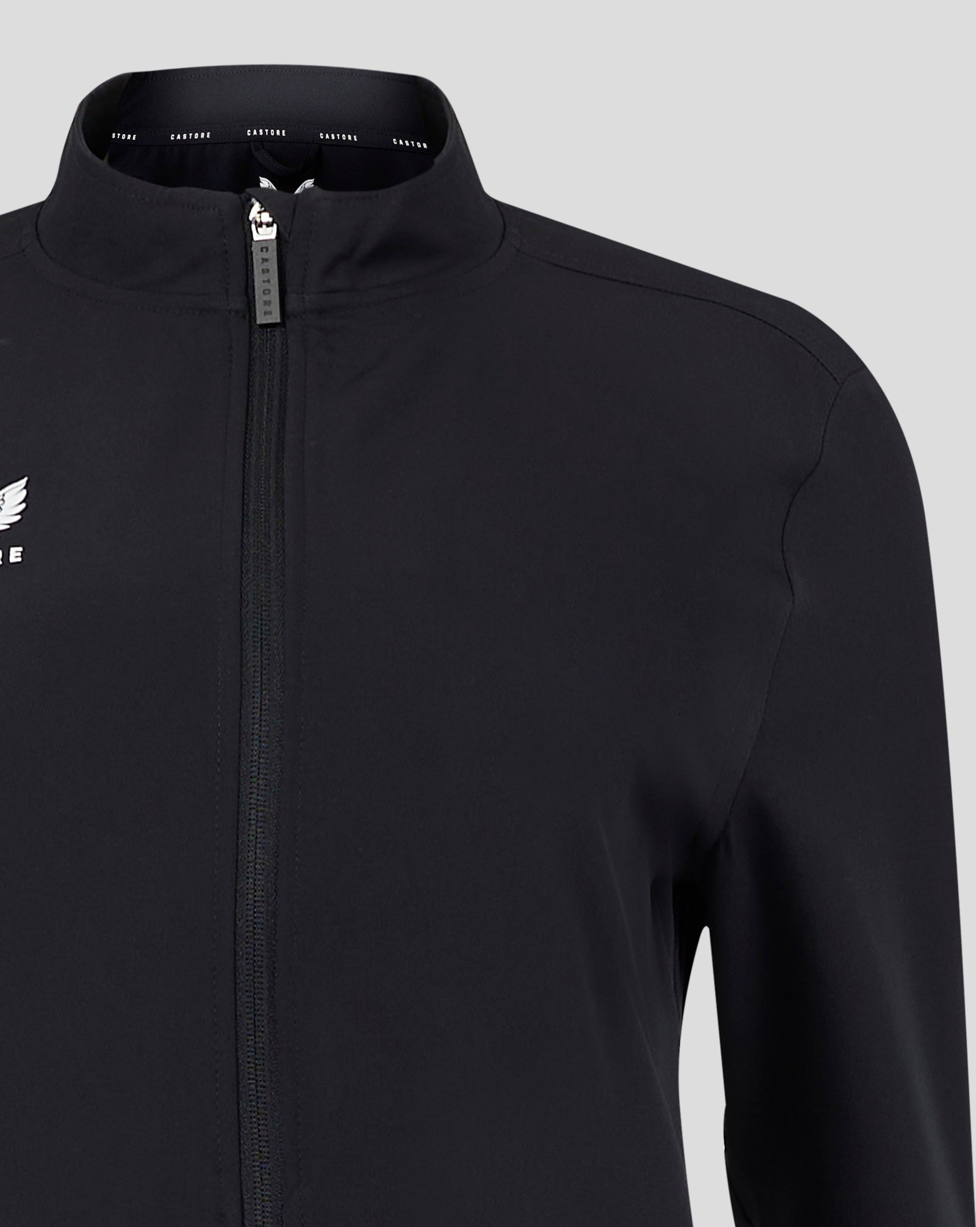 Zippered front of black jacket with visible white Castore logo on the left chest