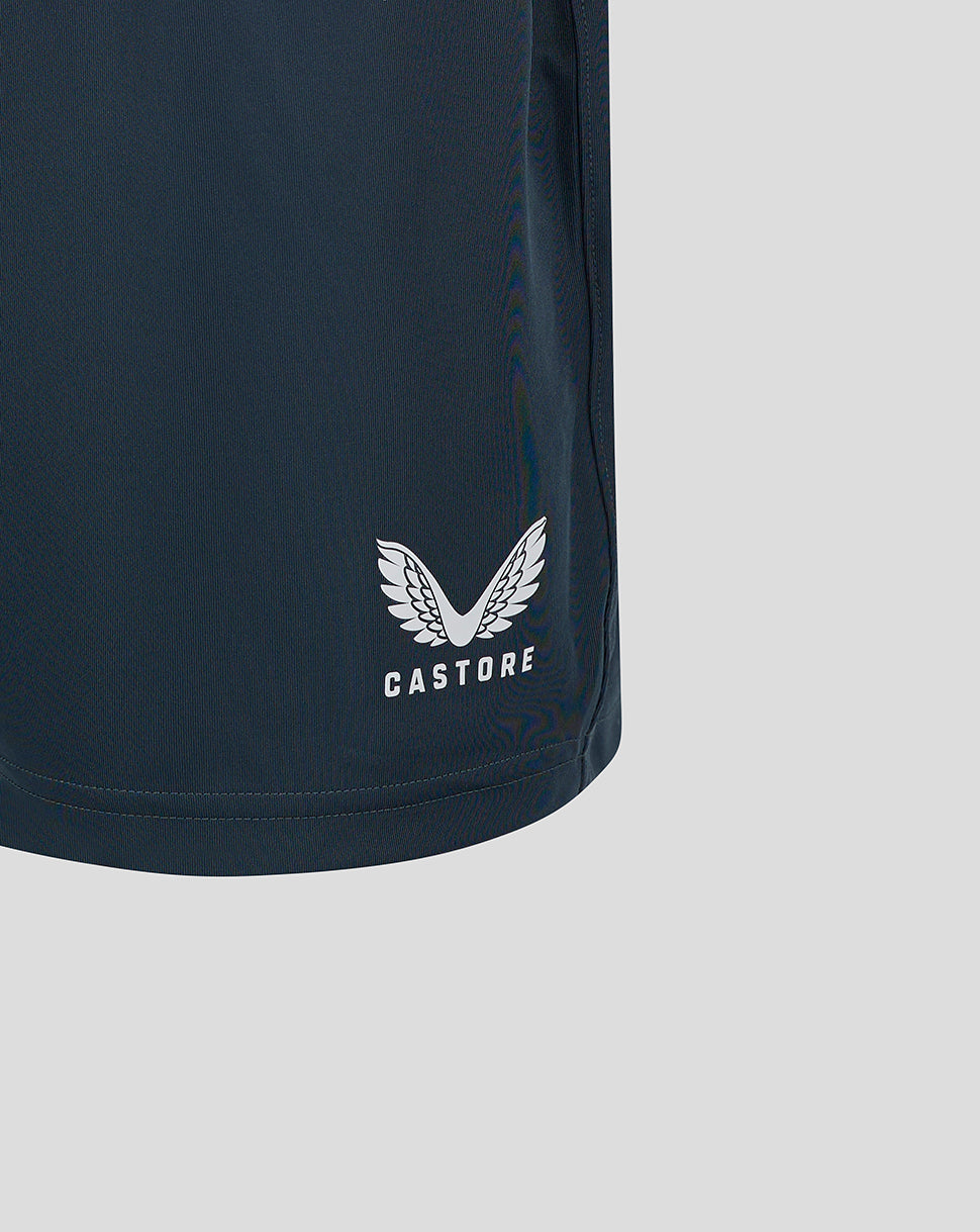 Close-up of the white Castore logo with wings on the dark slate shorts hem
