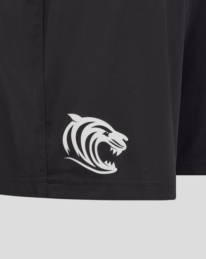 Close up of black training shorts fabric with a white tiger emblem