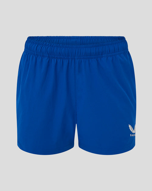 Close-up of blue woven training shorts waistband with elastic band and visible Castore crest on the leg.