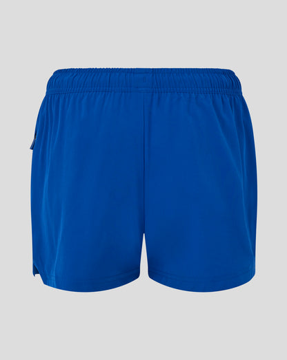 Back view of blue woven training shorts with elastic waistband and central rear seam