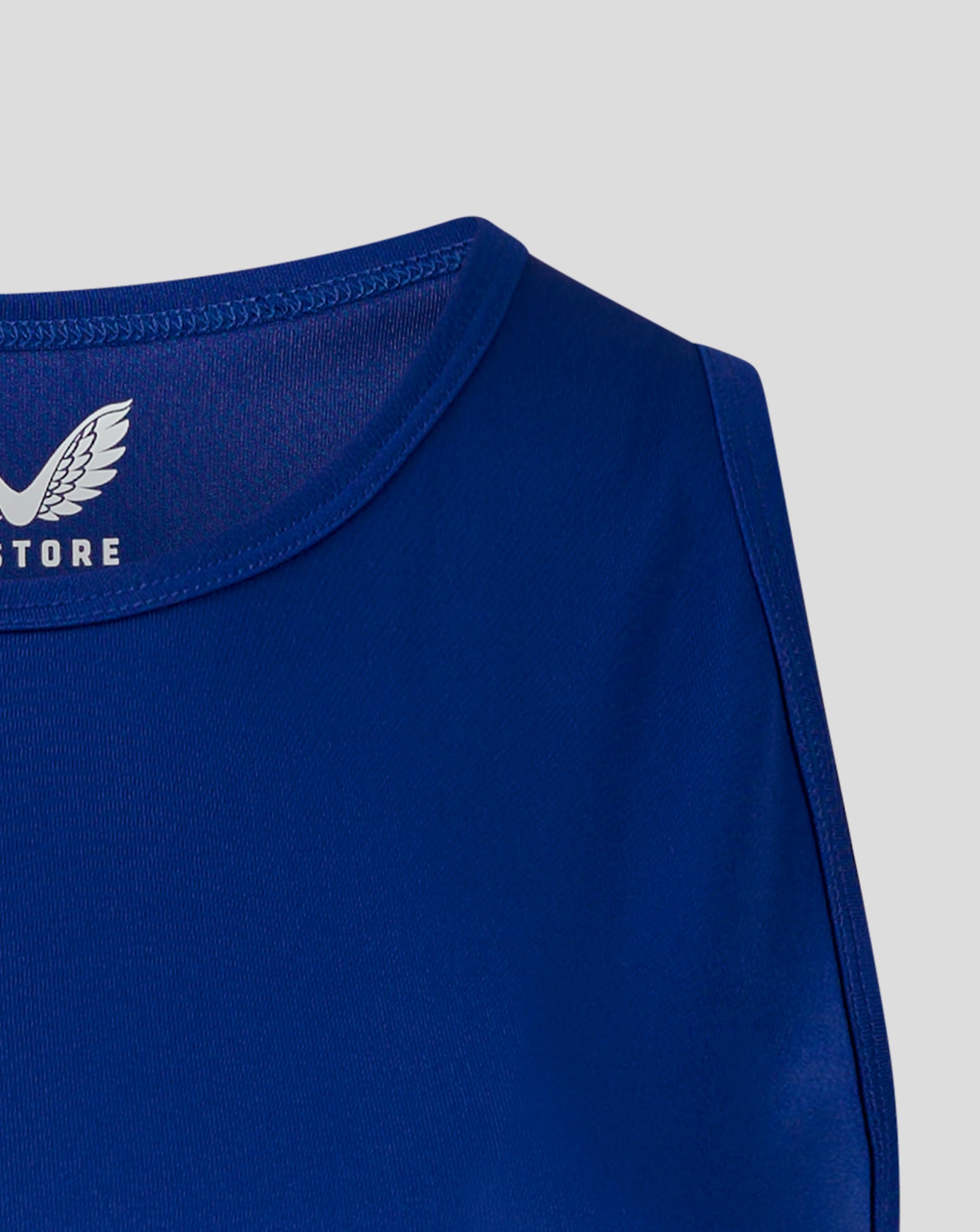 Blue training vest close up of neckline and shoulder with stitching and Castore branding