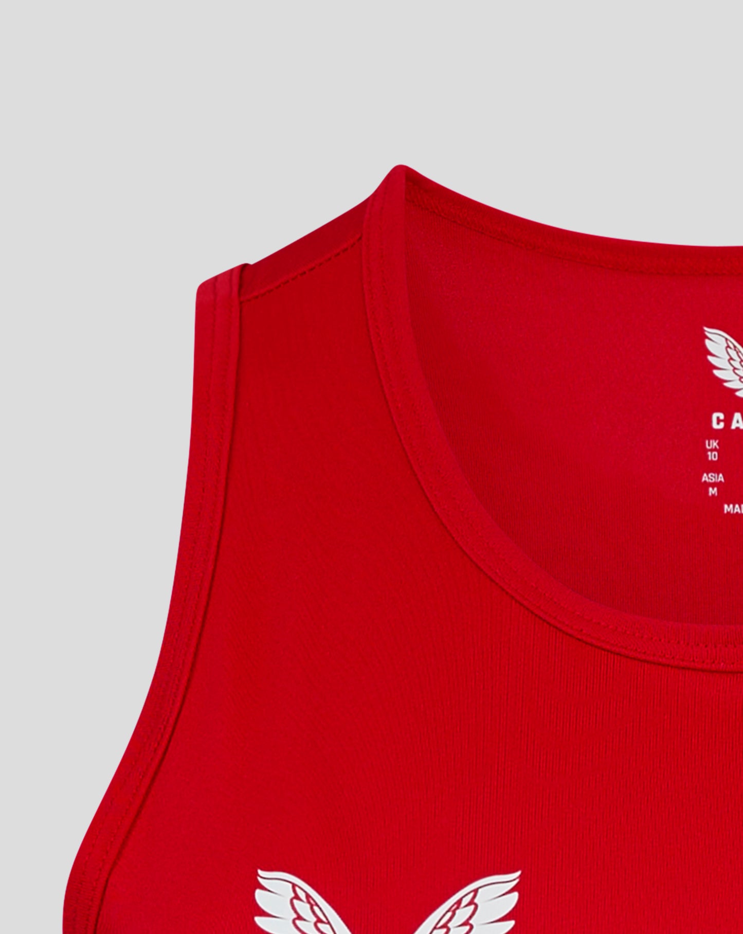Close up of shoulder seam and neckline on red vest with racer back