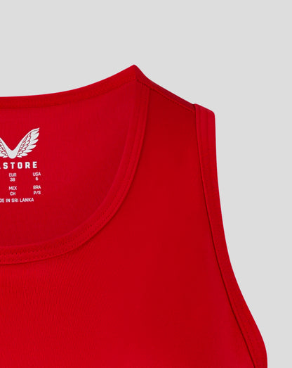 Close up of red womens training vest showing crew neck and racer back with heat sealed Castore logo