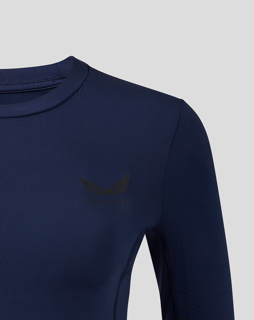 Close-up of navy Baselayer showing Castore logo on chest and smooth fabric texture