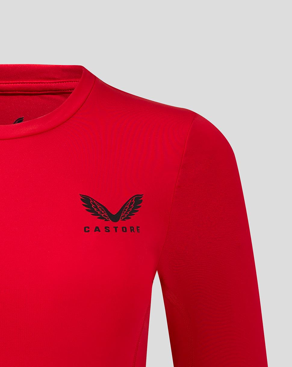 Close up of Castore logo on left chest of red long sleeve baselayer top