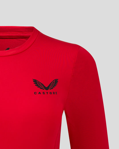 Close up of Castore logo on left chest of red long sleeve baselayer top