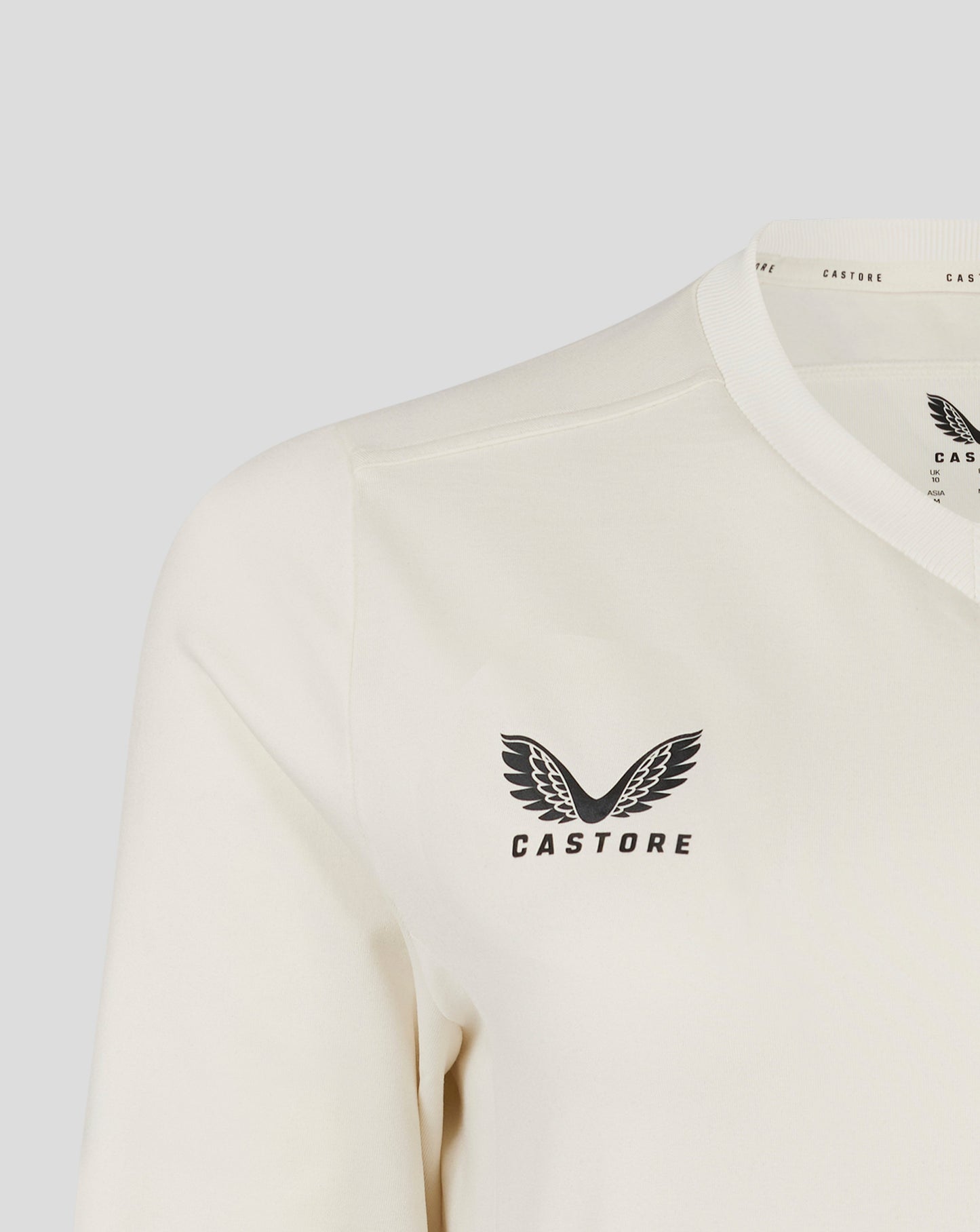 Close up of neck area on Cannoli Cream cricket jumper with ribbed collar and Castore branding along neck trim