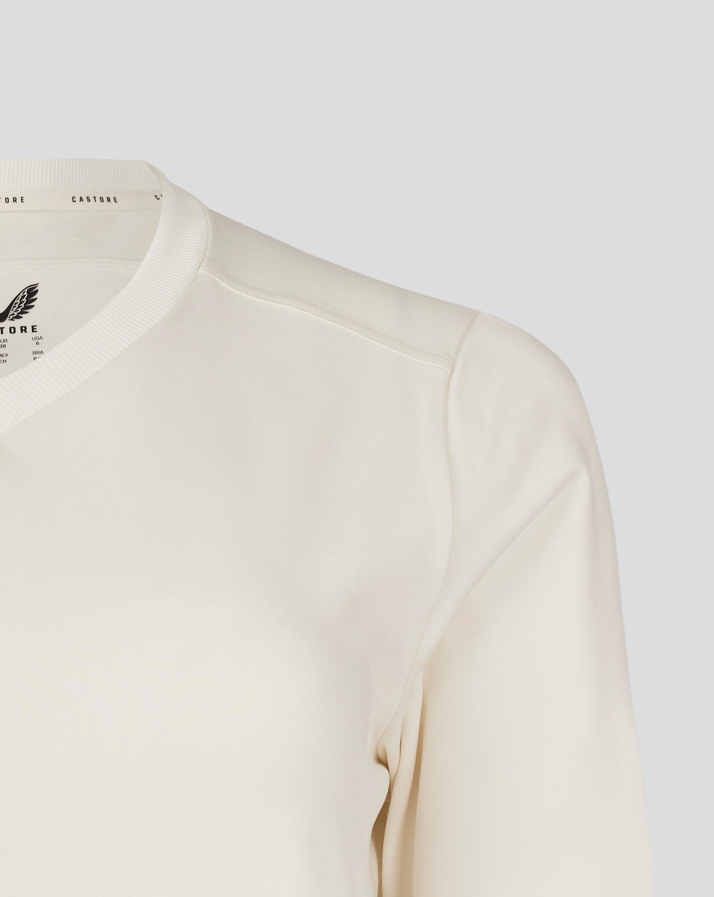 Front chest view of Cannoli Cream cricket jumper featuring a large Castore wing logo