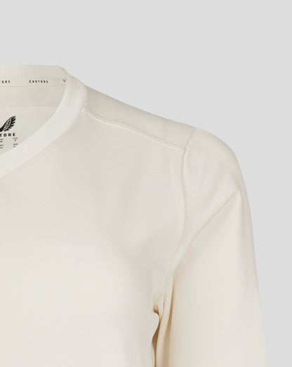 Front chest view of Cannoli Cream cricket jumper featuring a large Castore wing logo