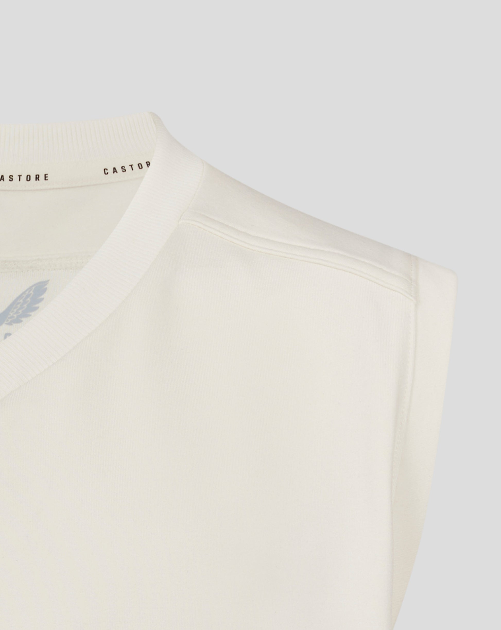 Front view of Cannoli Cream jumper with large black crest eagle logo and Castore branding