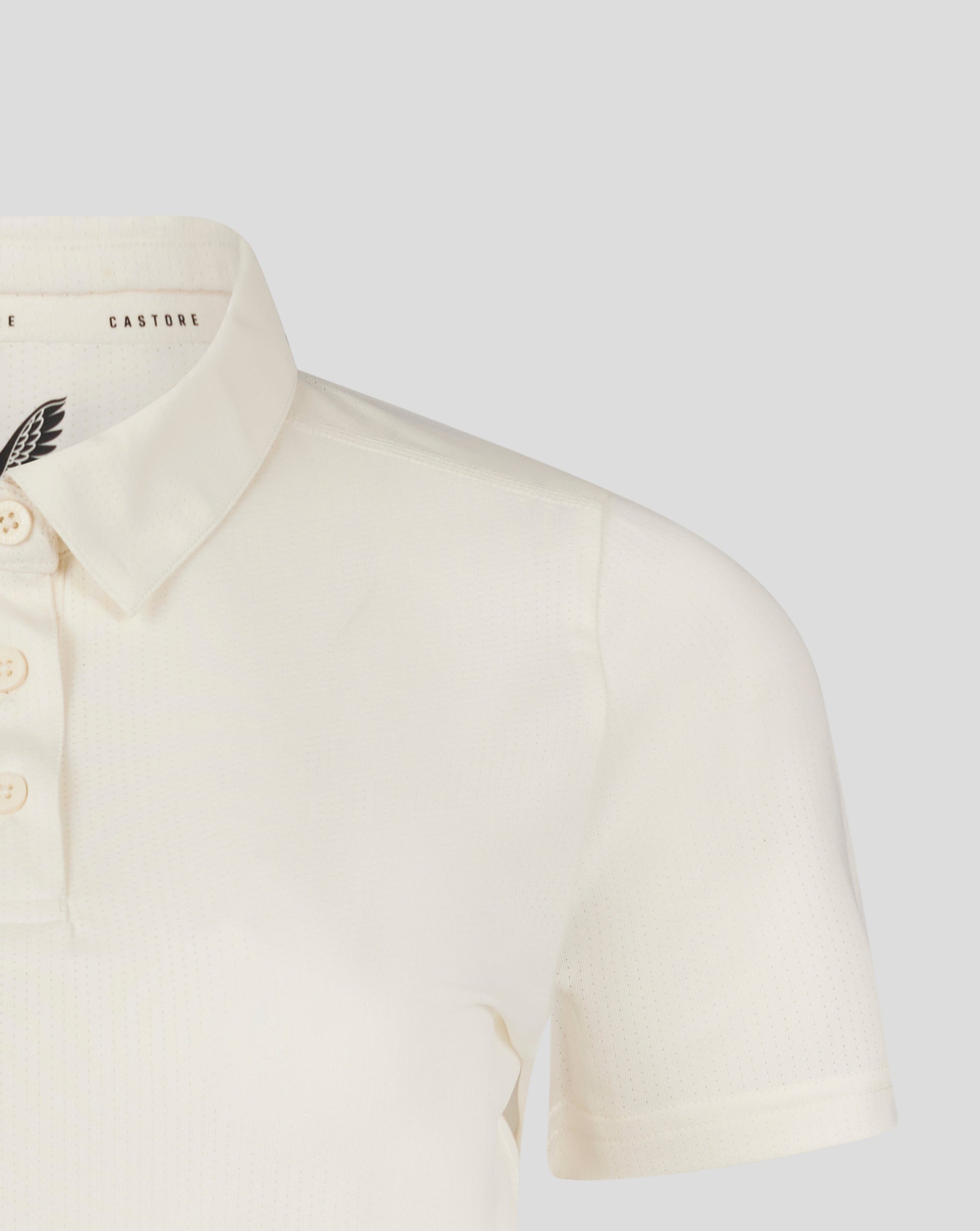 Cannoli Cream womens cricket tech playing shirt close up of collar and chest with Castore branding