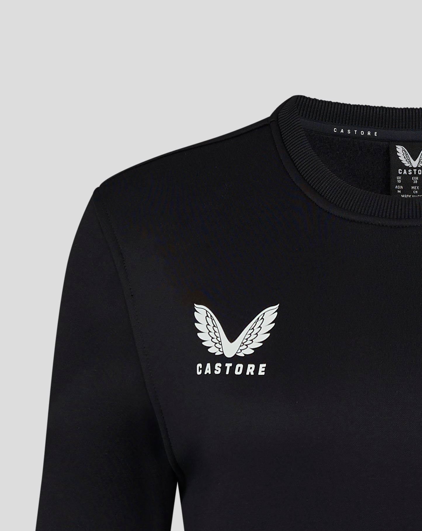 Close up of black Womens Brushback Sweatshirt in Caviar showing ribbed neckline and shoulder seam with Castore branding
