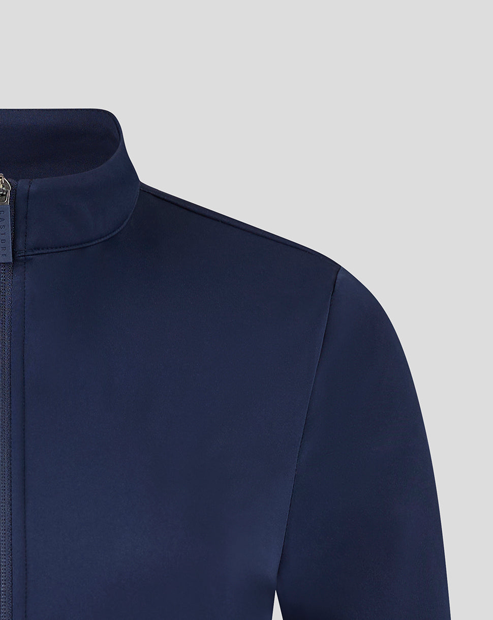 Close up of a navy soft shell jacket showing the high collar and zip placket.