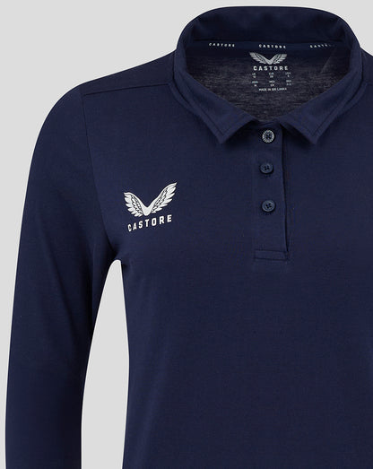 Closer view of navy polo at chest area with logo and shoulder seam detail