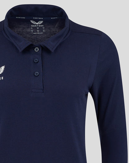 Close up of navy womens long sleeve polo with collar and three button placket showing chest logo
