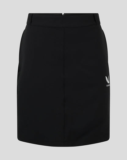 Front view of black women's chino skirt with white Castore logo at the hem