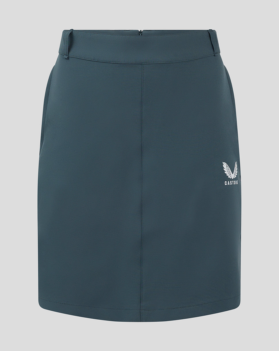 Front view of dark slate Womens Chino Skirt with a white Castore logo at the lower right.