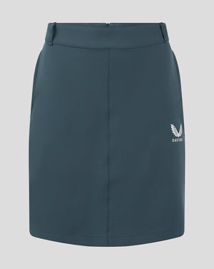 Front view of dark slate Womens Chino Skirt with a white Castore logo at the lower right.