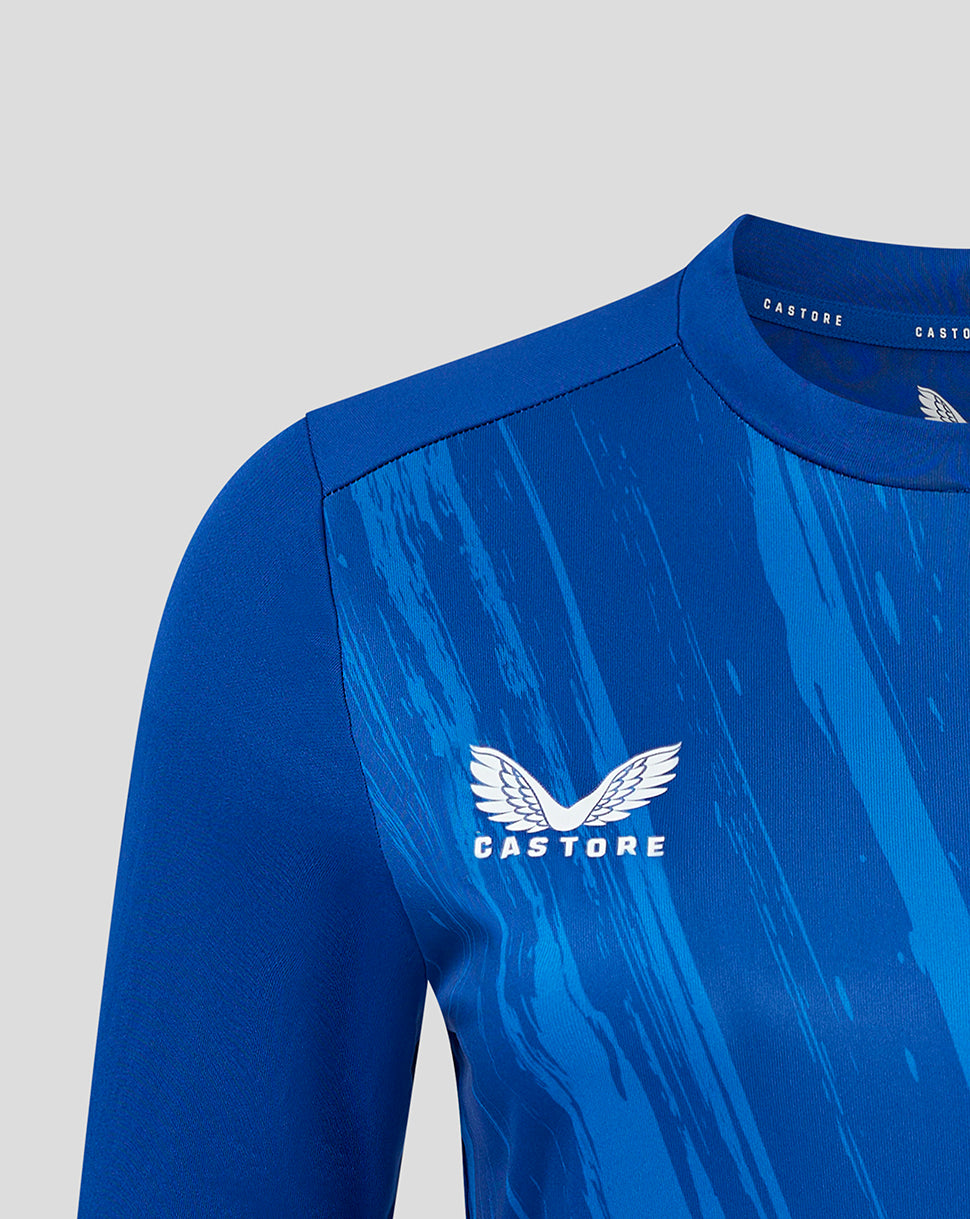 Close-up of blue T-shirt chest featuring the Castore wing logo on the patterned front