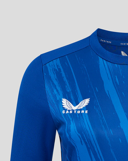 Close-up of blue T-shirt chest featuring the Castore wing logo on the patterned front