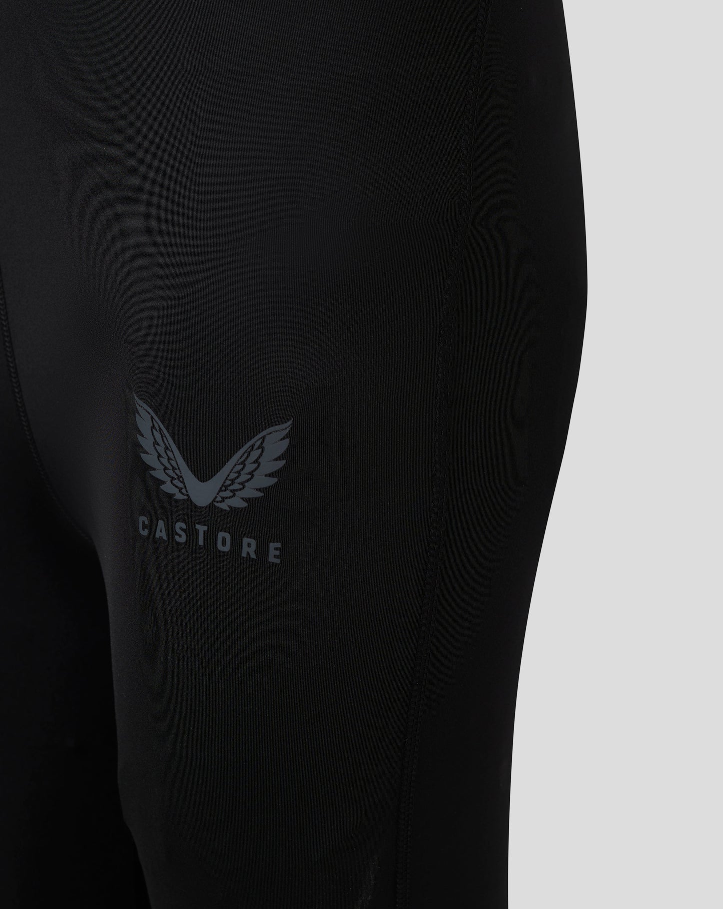 Close up of black Baselayer Legging showing Castore logo with laurel wings on the thigh
