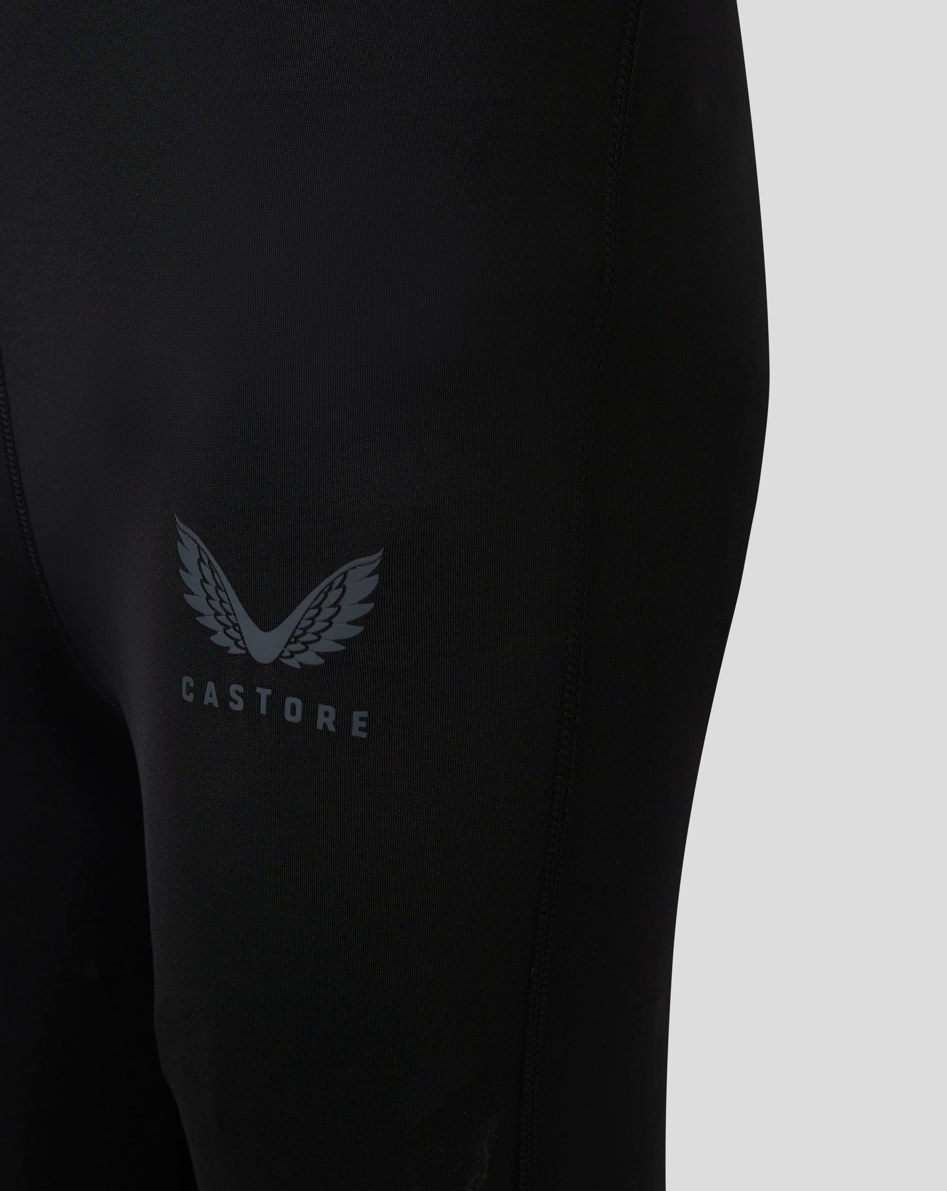 Close up of black Baselayer Legging showing Castore logo with laurel wings on the thigh