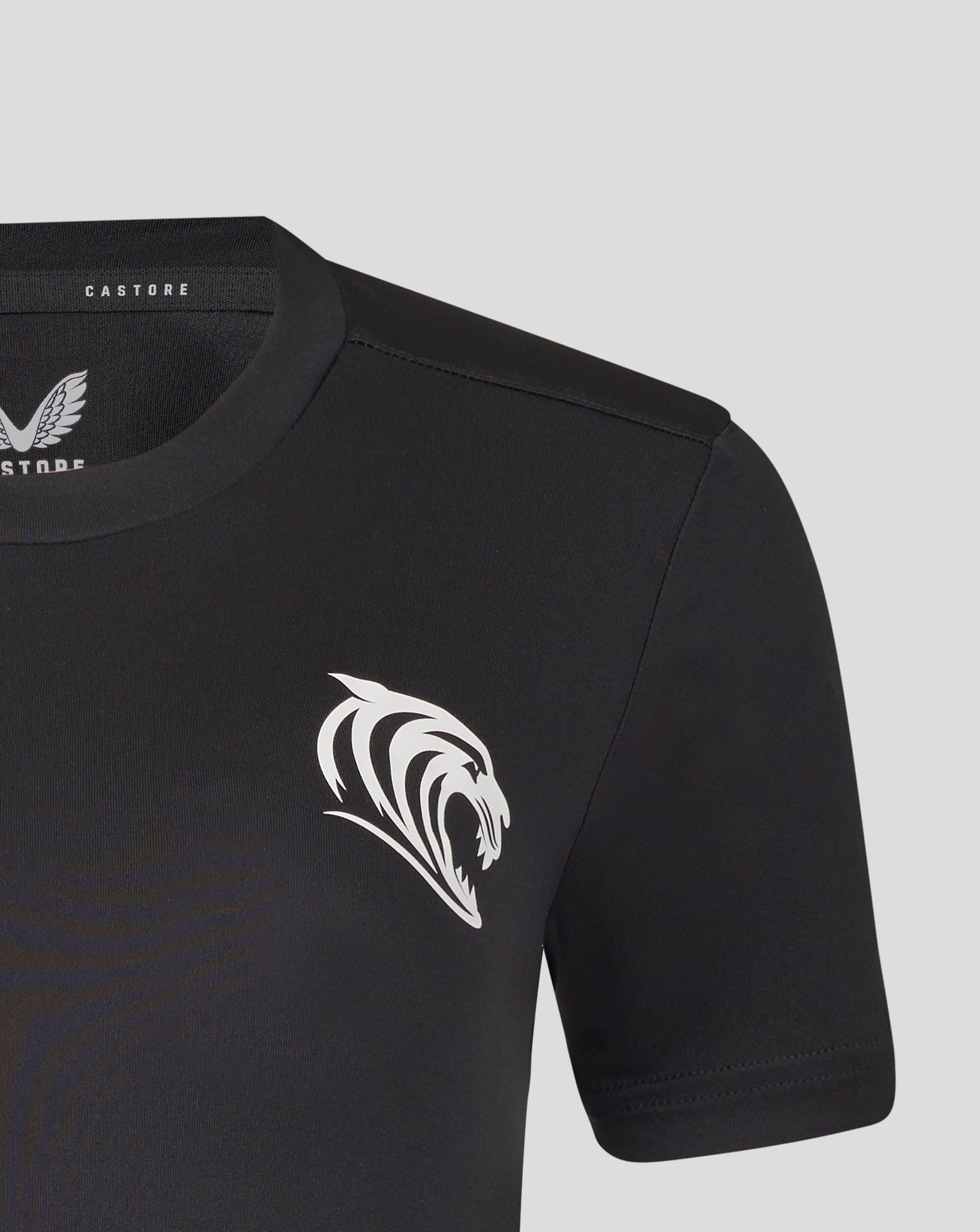 Close up of the black training T shirt neckline showing Castore label and a large white tiger crest on the chest