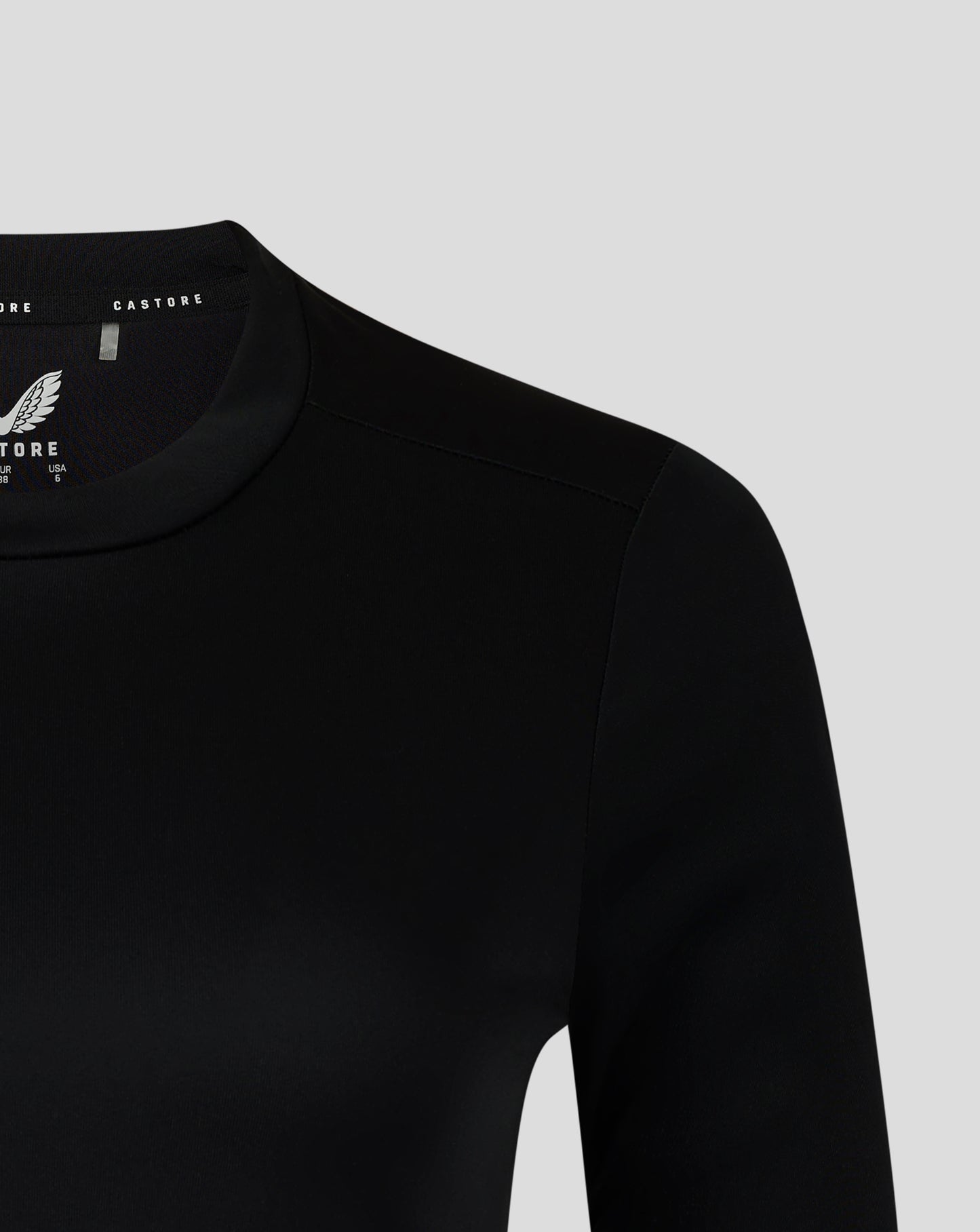 Inner collar view with Castore branding and white wing logo on black tee