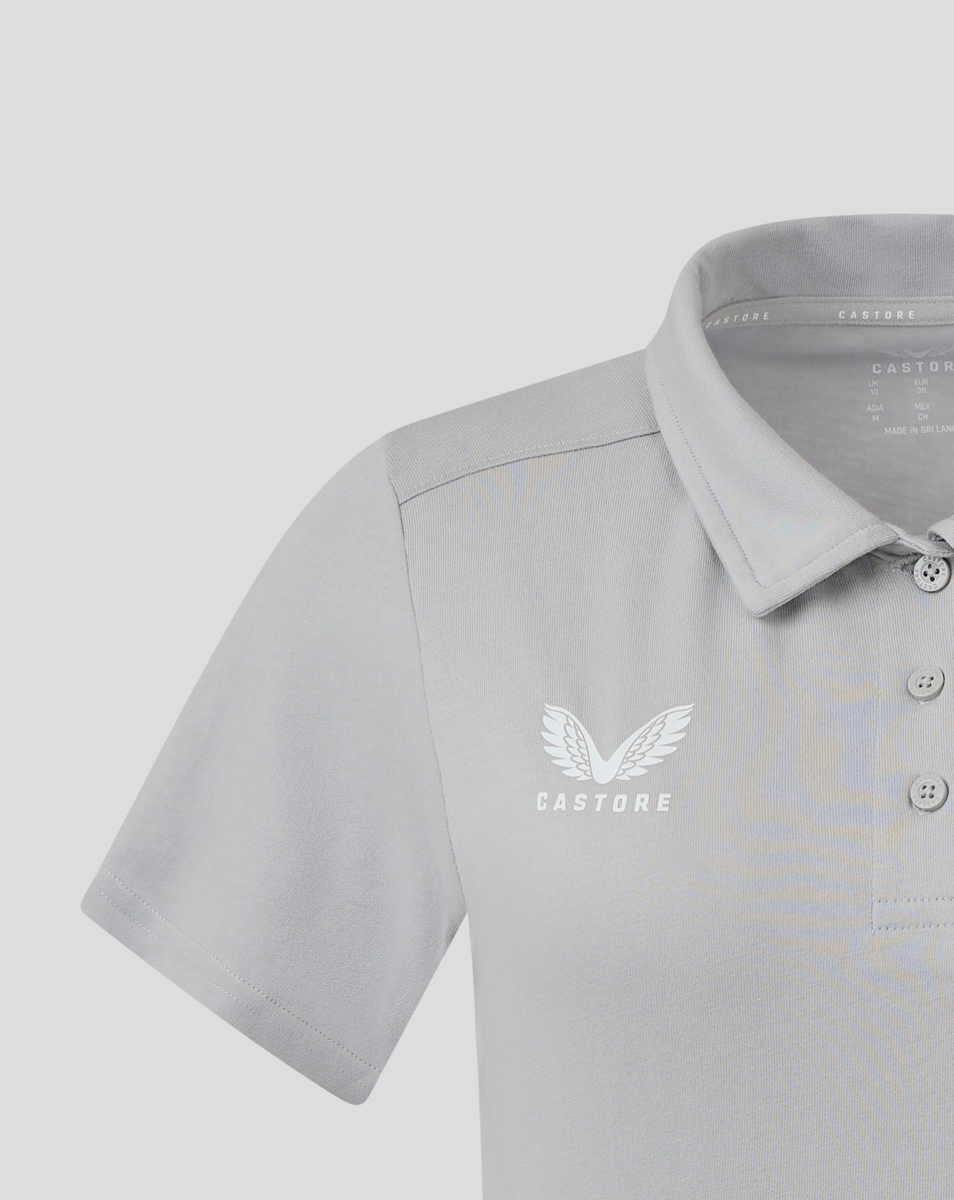 Close up of front chest on light gray Women's Cotton Leisure Polo with white Castore wings logo