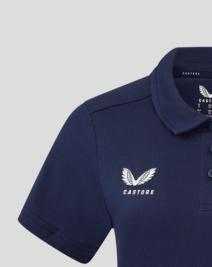Close up of left chest area on navy polo with white Castore wing logo and collar visible