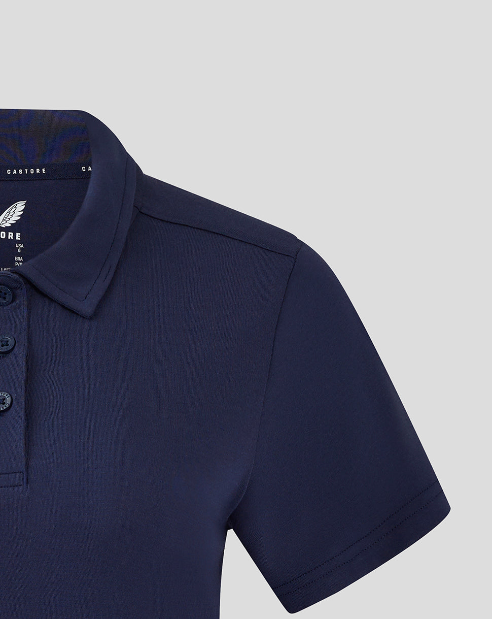 Close view of navy women's polo sleeve and shoulder showing seam and fabric texture
