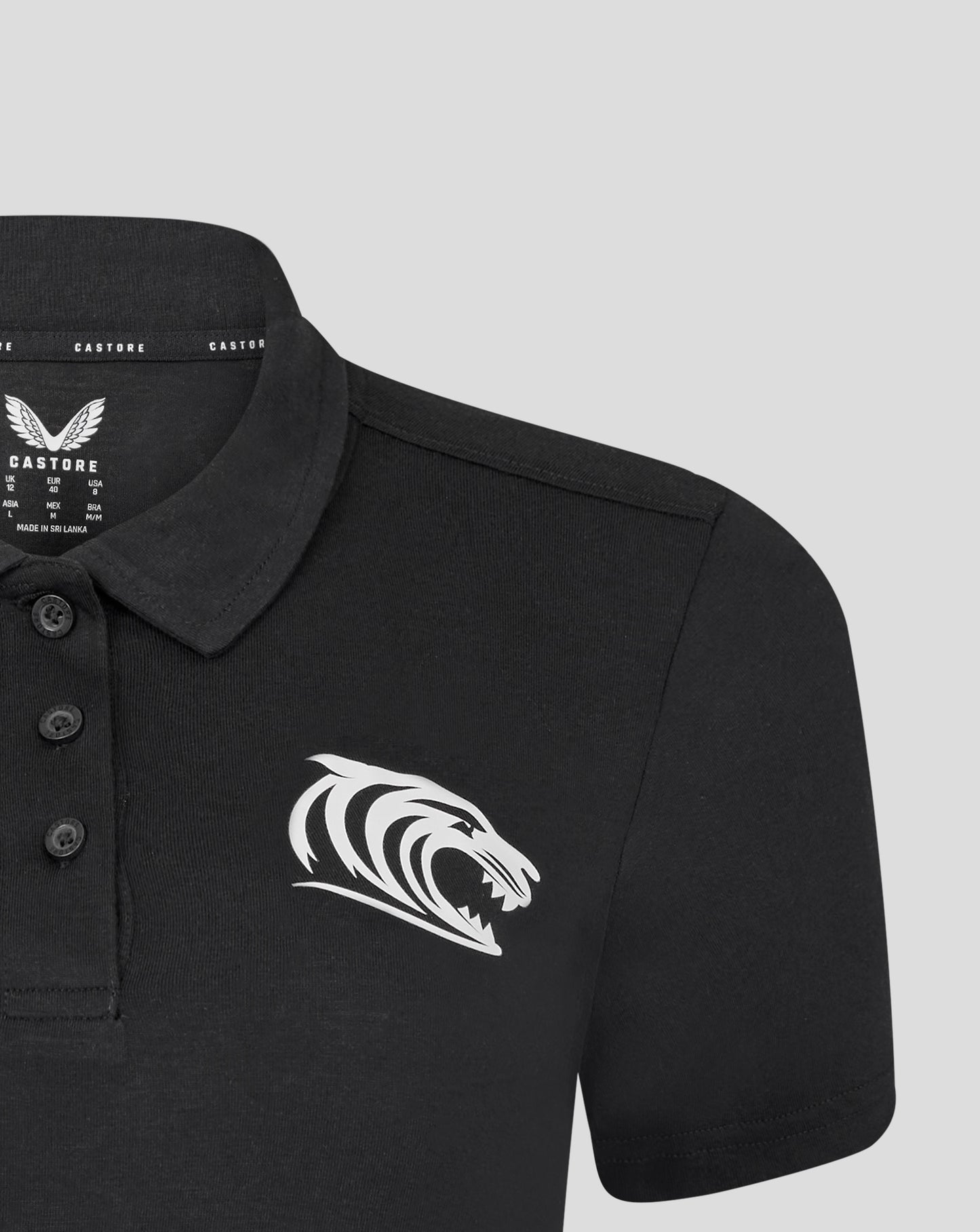 Leicester Tigers women's training polo in black featuring a large white tiger graphic across the front