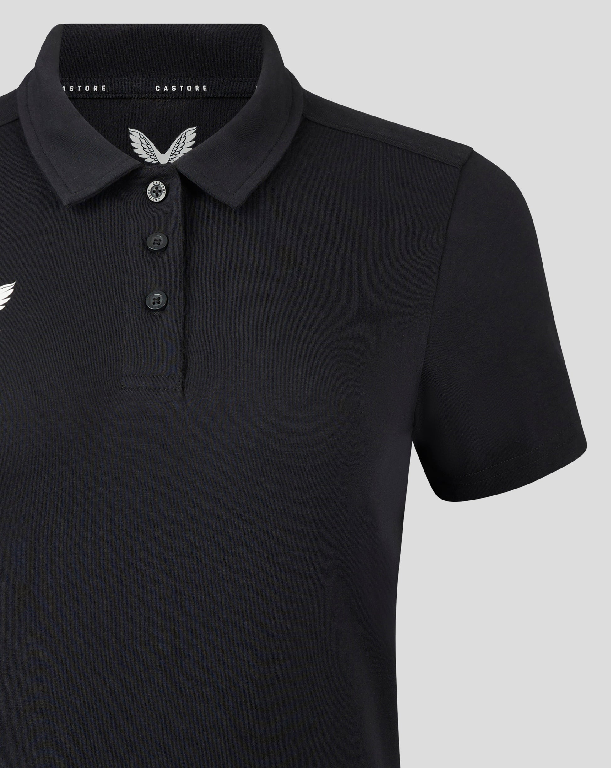 Front view of black polo featuring three button placket and white Castore crest on the left chest.