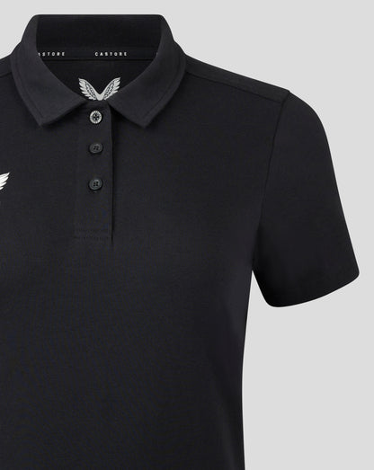 Front view of black polo featuring three button placket and white Castore crest on the left chest.