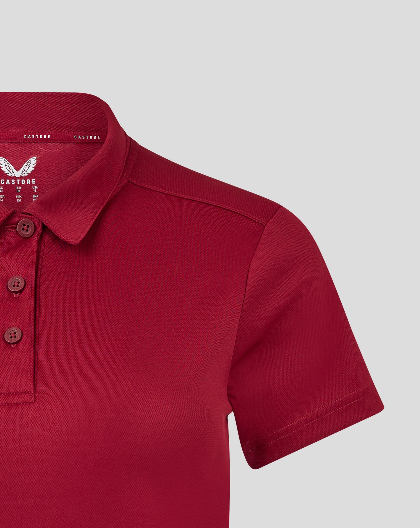 Close up of collar area featuring the Castore branding inside the red polo