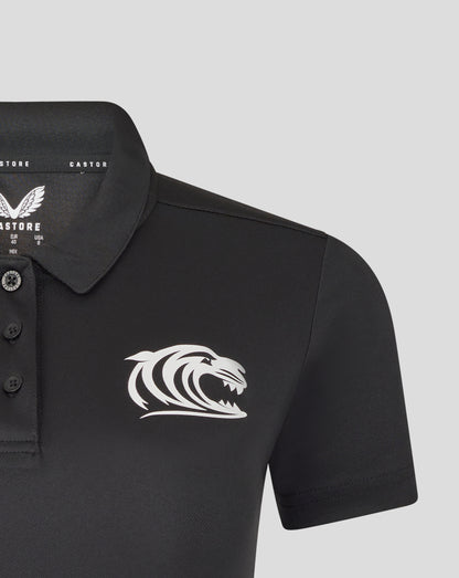 Close up of black polo chest featuring tiger crest on the left and branding at the collar interior