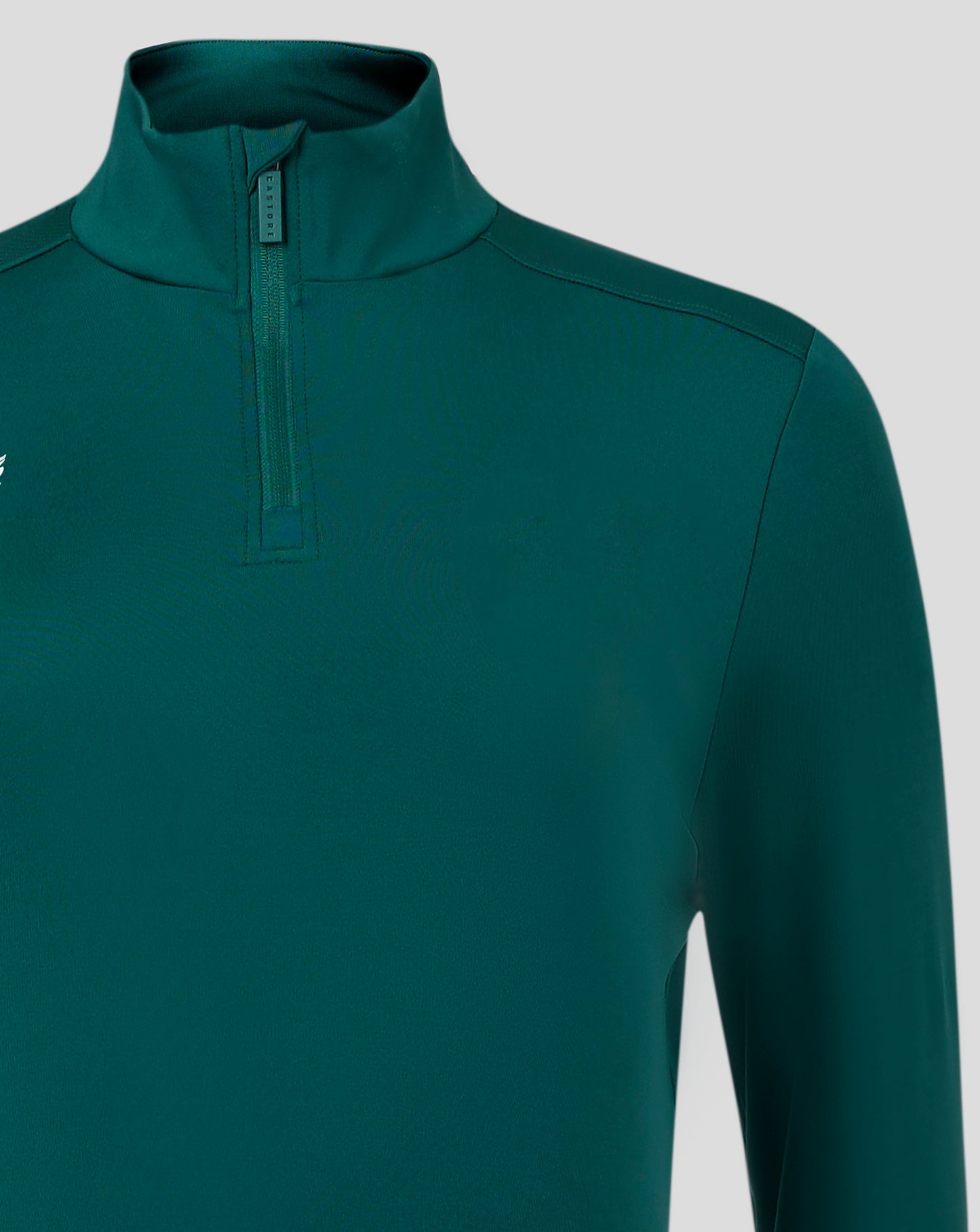 Teal womens 1/4 zip top with funnel neck and chin guard at zipper showing front seams and Castore logo